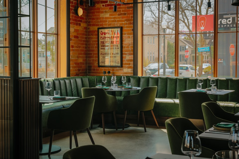 Empty restaurant with green seating — The Junction Stouffville case study