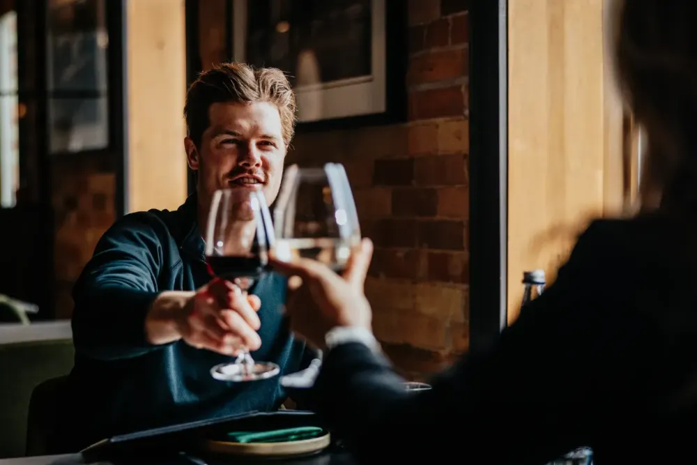 Two people clinking wine glasses — The Junction Stouffville case study